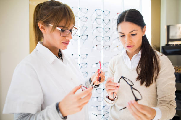 istock Woman selecting eyeglasses in optical shop 827550596