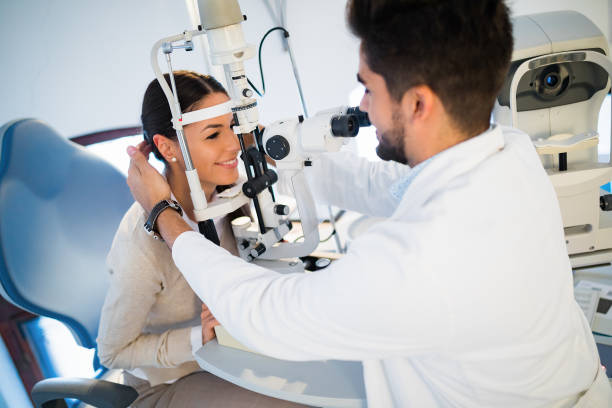 istock Young woman having her eyes examined by optometrist. 827552876