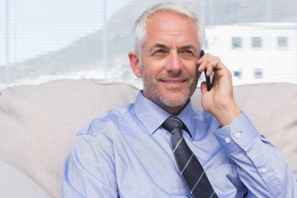 istock Cheerful businessman calling on smartphone 827559602