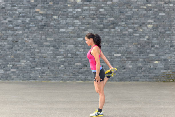 istock Young woman doing warming up exercises 827561974