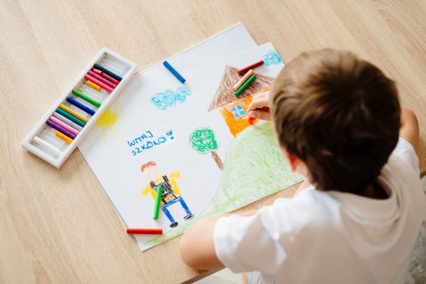 Child drawing picture of boy going to school. Child drawing picture of boy going to school. Hello School in Polish language. pastel crayon photos stock pictures, royalty-free photos & images