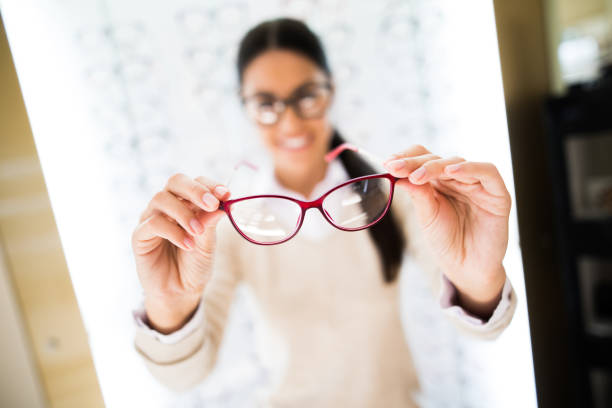 istock Woman selecting eyeglasses in optical store 827563716
