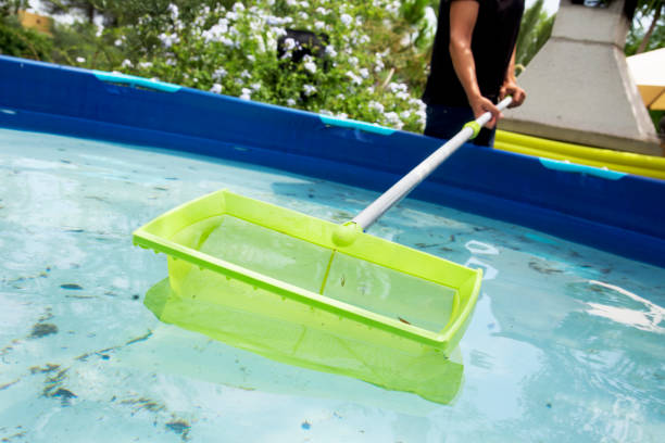 istock young man cleaning a portable swimming pool 827567178
