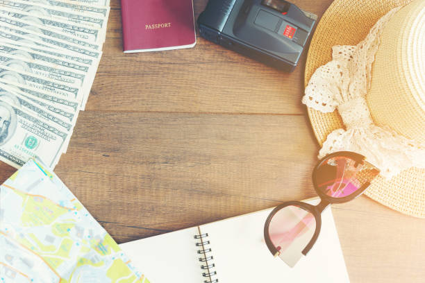 istock Travelling concept : Passport , notebook , map , U.S. dollar bills , camera , hat and eyeglasses 827567254