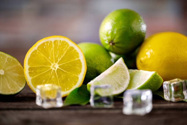 raw sliced lemons and lime summer freshness fruits background