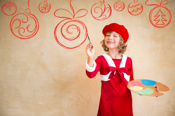 istock Child painting Christmas decorations 827571850