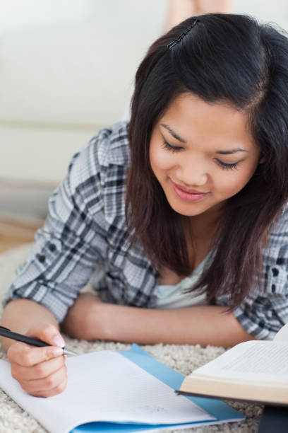istock Woman lying on the floor looking at a notebook 827576172