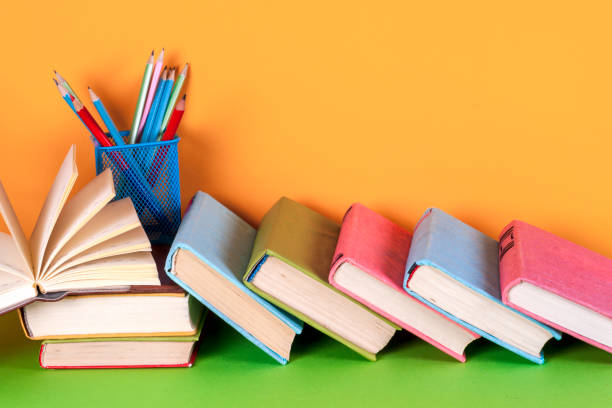 istock Open book, hardback books on bright colorful background. 827578706