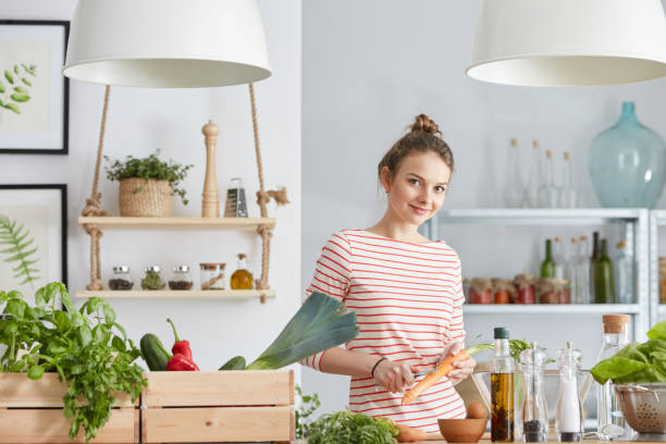 istock Woman peeling carrot 827581974