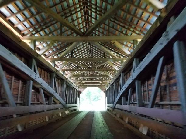 istock light at end of wooden covered bridge 827586760