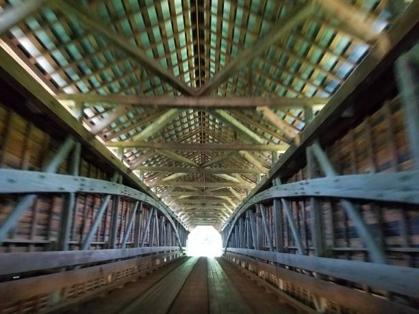 istock light at end of wooden covered bridge 827586802