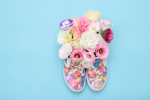 istock Beautiful gumshoes with flowers inside on bright background 827591712