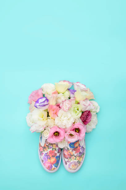 istock Beautiful gumshoes with flowers inside on bright background 827592260