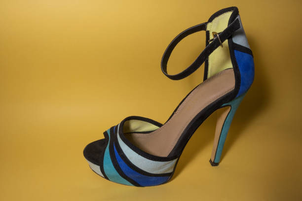 istock Woman shoes on yellow background 827592546