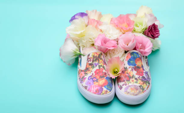 istock Beautiful gumshoes with flowers inside on bright background 827595876
