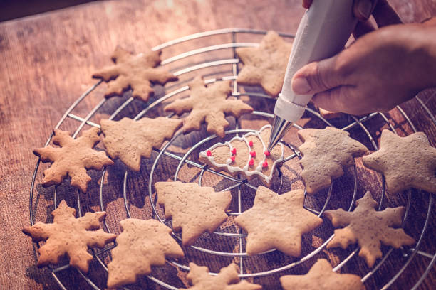 Decorating gingerbread Christmas Cookies with colorful icing