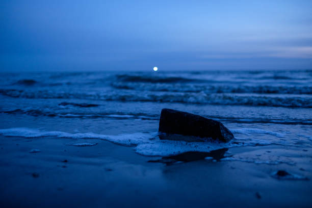 istock blue sunset with lighthouse light at north coast 827600712