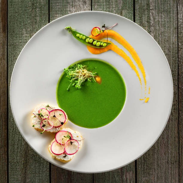 istock Pea cream soup in rim soup plate 827603432