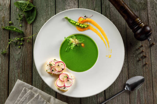 istock Pea cream soup in rim soup plate 827603644