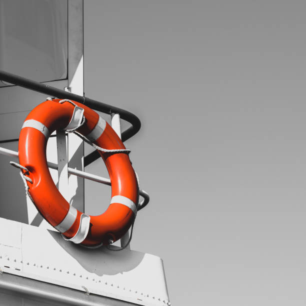 Bright orange lifebuoy on a white yacht side