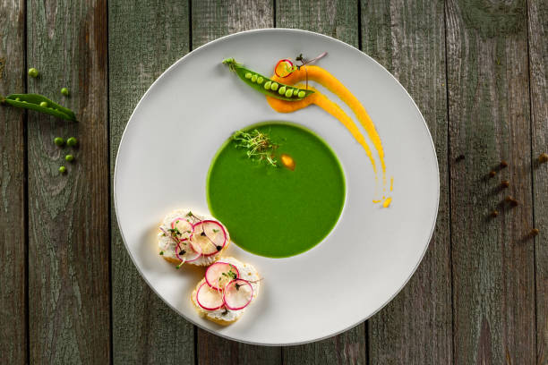istock Pea cream soup in rim soup plate 827603986