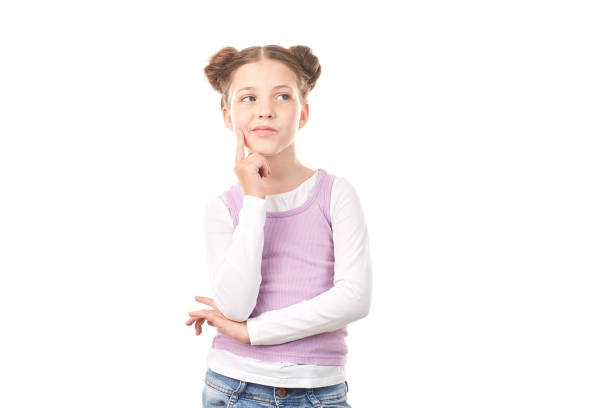 Portrait of beautiful little girl with hair buns against white background