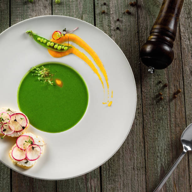 istock Pea cream soup in rim soup plate 827604320
