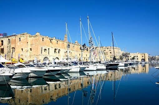 View of Senglea and marina and waterfront buildings seen from Vittoriosa with people going about their business, Senglea, Malta, Europe.