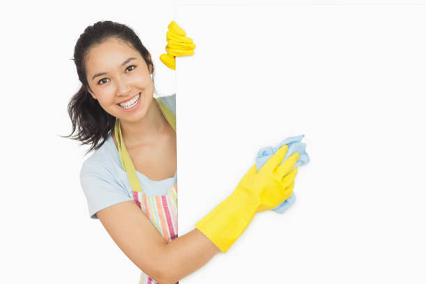 istock Cheerful woman cleaning white surface 827608762