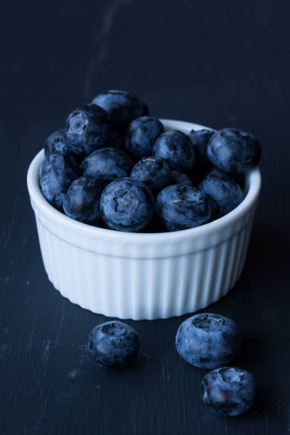 istock Blueberries in a bowl on a black background 827614934