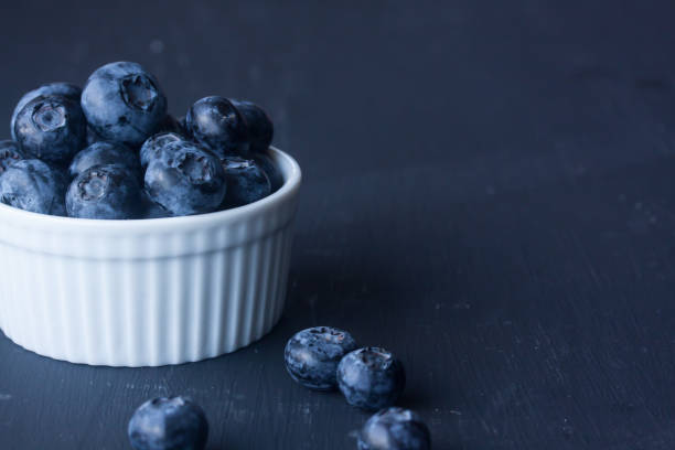 istock Blueberries in a bowl on a black background 827614984