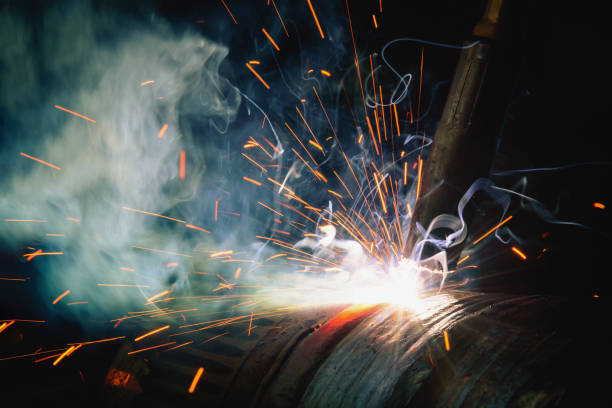 istock Welding steel structures and bright sparks in steel construction industry. 827615190