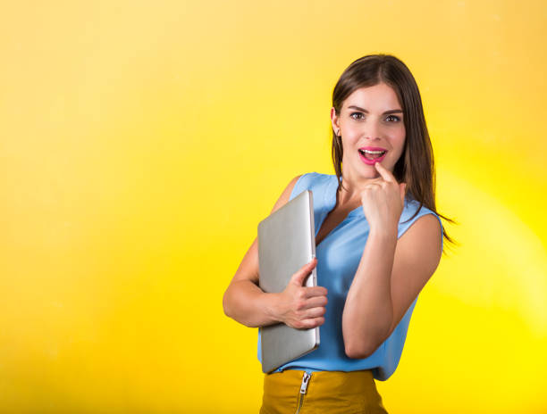 istock Beautiful young woman with laptop 827619170