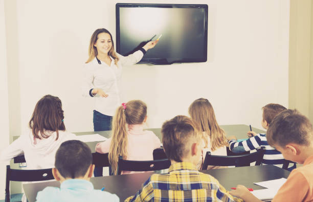 istock Boys and girls with teacher 827620474