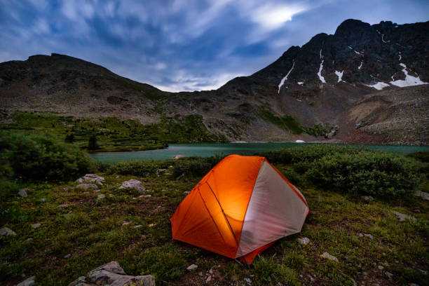istock Tent Glowing Under Moonlit Sky and Mountains 827624418