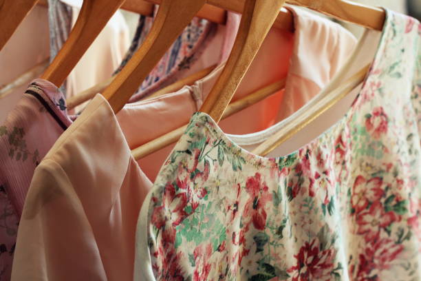istock collection of women's clothes hanging on rack 827627304