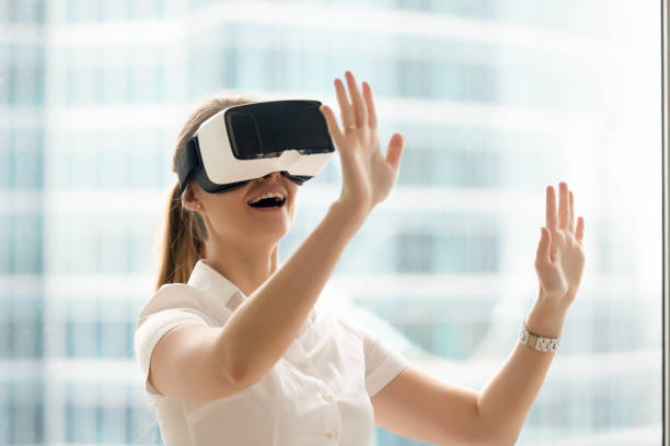 istock Curious amazed woman trying augmented reality glasses, virtual life experience 827627444