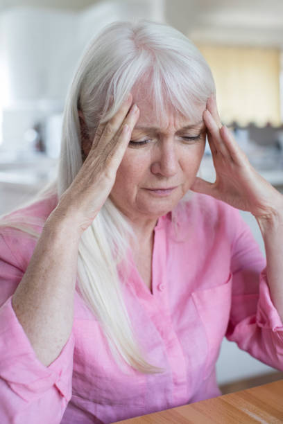 istock Mature Woman At Home Suffering From Headache 827627622