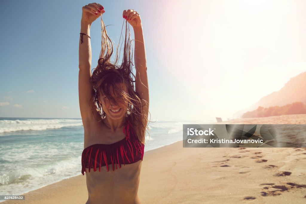 Woman on the tropical beach enjoying life. Confidence Stock Photo