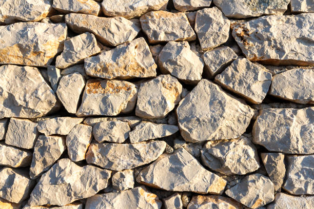 istock Sunset on surface of stone wall 827628440