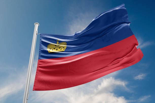istock Liechtenstein Flag is Waving Against Blue Sky 827629204