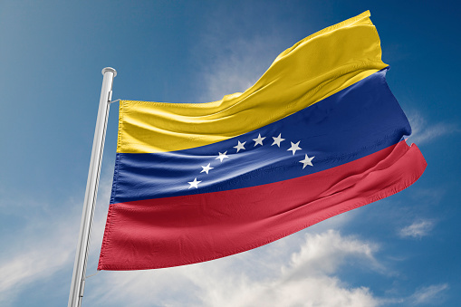 Venezuela flag is waving at a beautiful and peaceful sky in day time while sun is shining. 3D Rendering