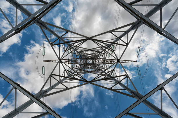 istock high voltage pylons on blue cloudy sky background 827631298