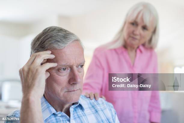 Mature Woman Comforting Man With Depression At Home Stock Photo - Download Image Now