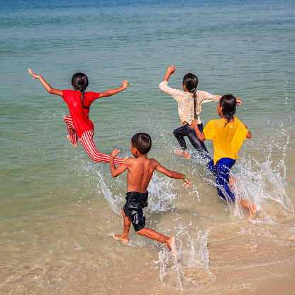 Cambodian little children having fun in the sea, Cambodia