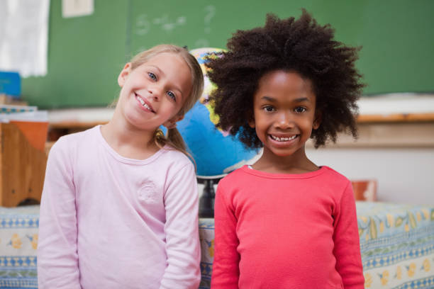 istock Cute schoolgirls posing 827642198