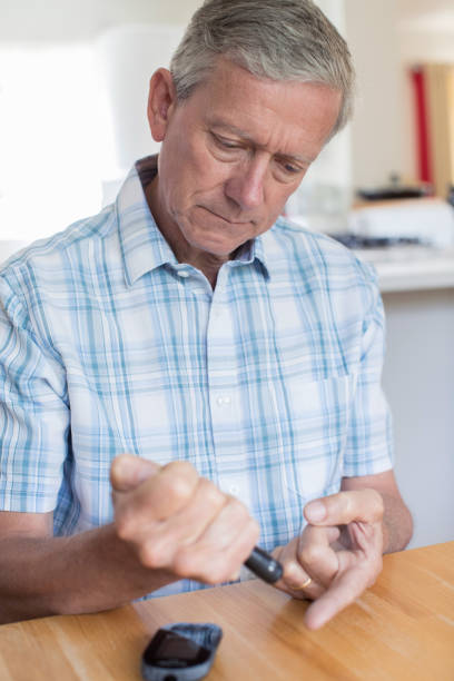 istock Mature Man Testing Blood Sugar Level At Home 827642446