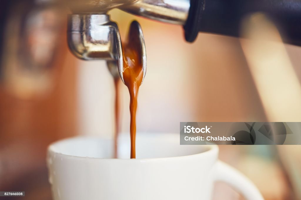 Prepartion of the espresso coffee Detail of a coffee machine. Prepartion of the espresso in coffee shop. Espresso Maker Stock Photo