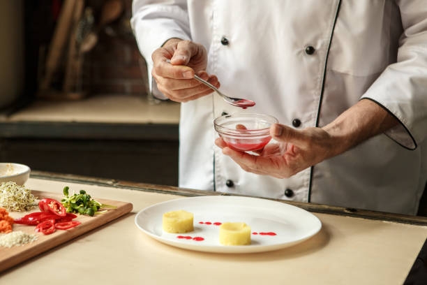 istock Mature man professional chef cooking meal indoors 827647090