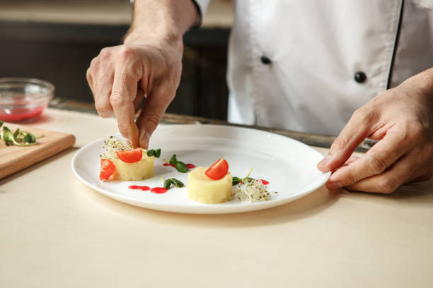 istock Mature man professional chef cooking meal indoors 827647384